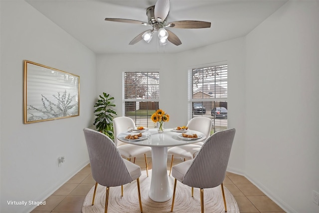 tiled dining space with ceiling fan