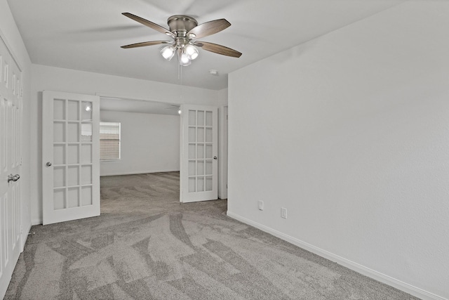 spare room with carpet flooring, ceiling fan, and french doors