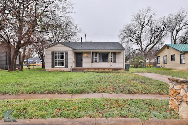 view of front facade with a front yard and central air condition unit