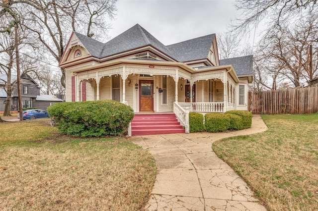 victorian home with covered porch and a front yard