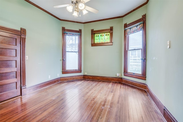 unfurnished room featuring light hardwood / wood-style flooring, ornamental molding, and ceiling fan