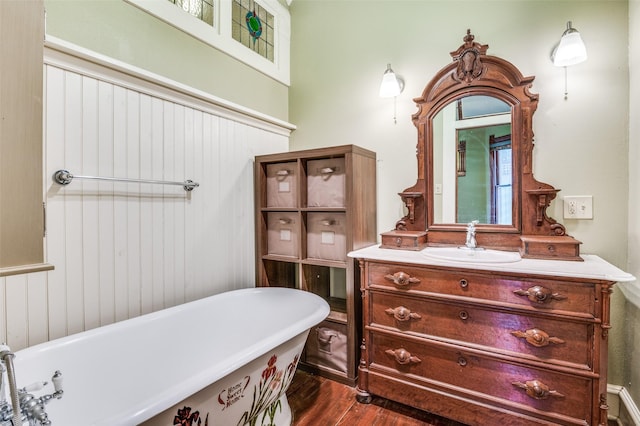 bathroom featuring wood-type flooring, a bath, and vanity