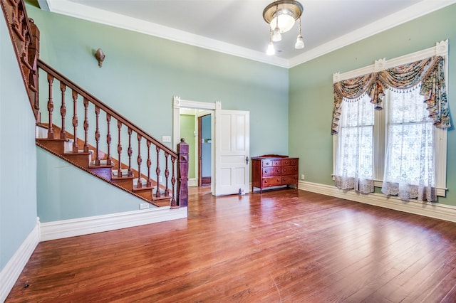 foyer featuring crown molding and hardwood / wood-style floors