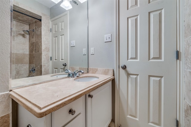 bathroom featuring vanity and tiled shower