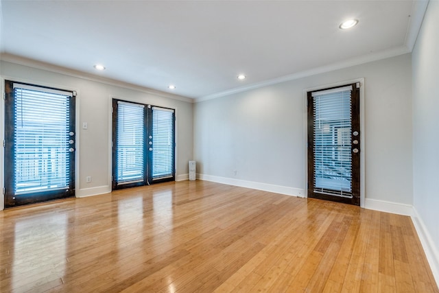 spare room with light hardwood / wood-style flooring and ornamental molding