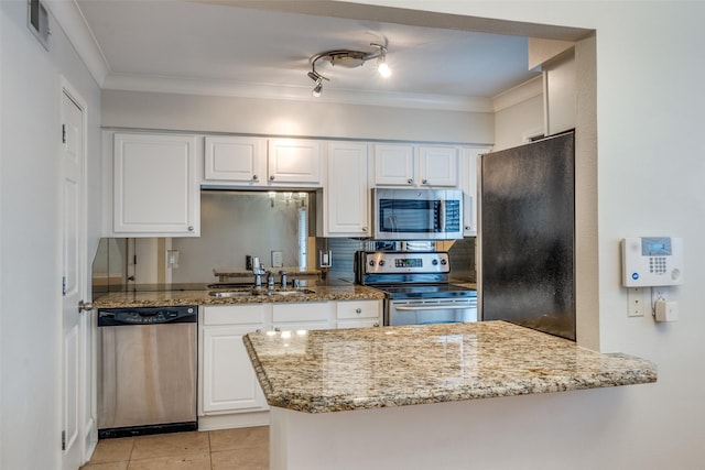 kitchen featuring sink, stainless steel appliances, light stone counters, white cabinets, and kitchen peninsula