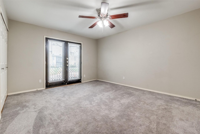 carpeted empty room featuring ceiling fan and french doors