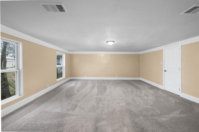 315 Park St, Commerce, TX 75428 - carpeted spare room with baseboards, a textured ceiling, and ornamental molding