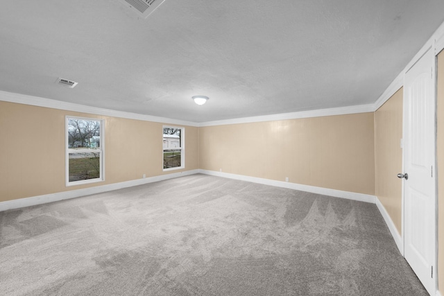 315 Park St, Commerce, TX 75428 - carpeted spare room with crown molding, baseboards, and a textured ceiling