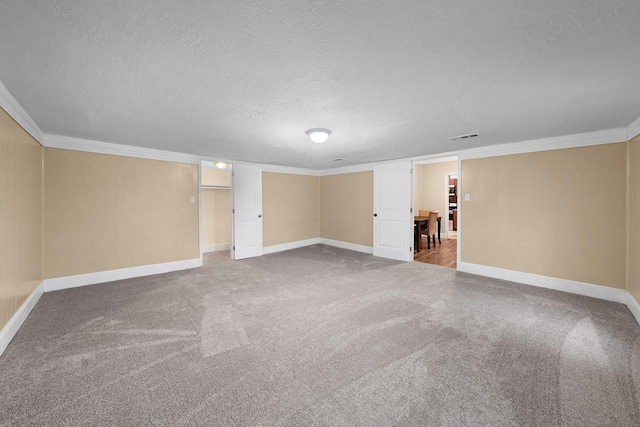 315 Park St, Commerce, TX 75428 - finished below grade area with ornamental molding, carpet, a textured ceiling, and baseboards