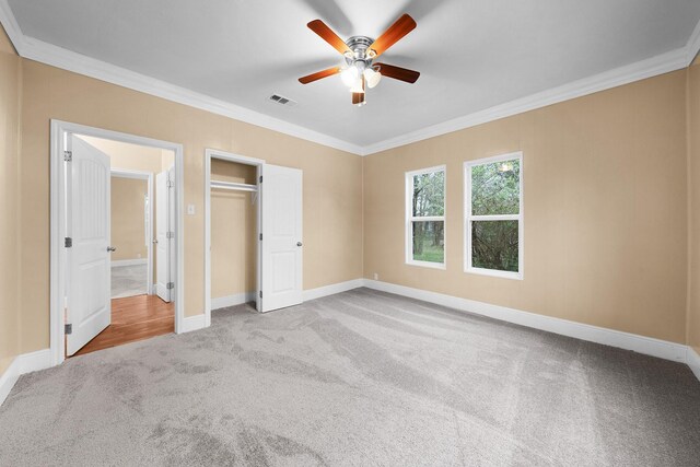 315 Park St, Commerce, TX 75428 - unfurnished bedroom with carpet flooring, crown molding, baseboards, ceiling fan, and a closet