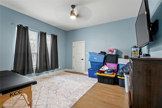 interior space featuring wood-type flooring and ceiling fan