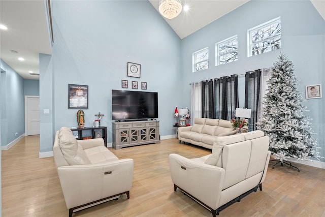 living room featuring light hardwood / wood-style floors and high vaulted ceiling