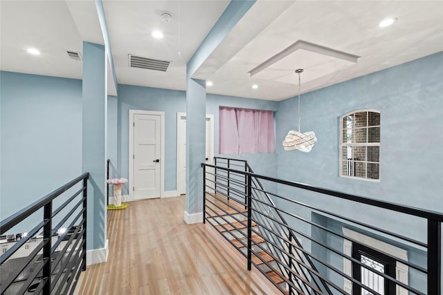 corridor with light hardwood / wood-style flooring