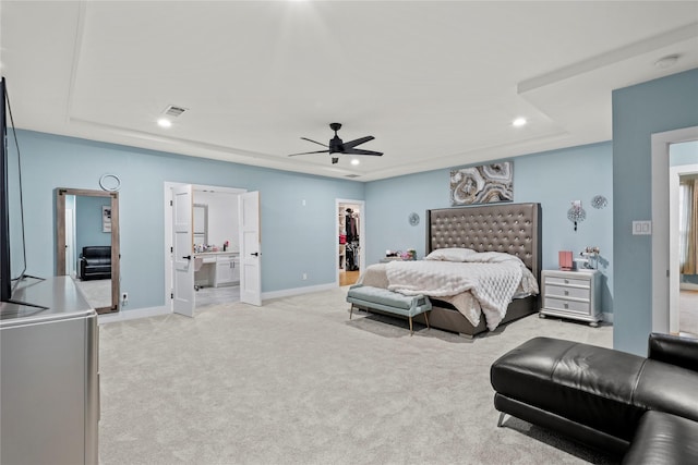 carpeted bedroom featuring ceiling fan, connected bathroom, a spacious closet, and a closet