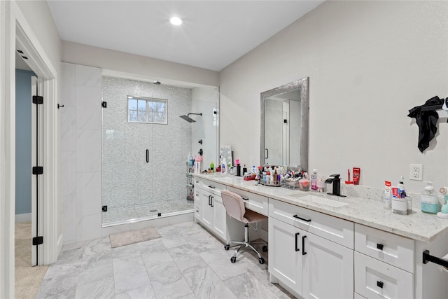 bathroom with vanity and a shower with door