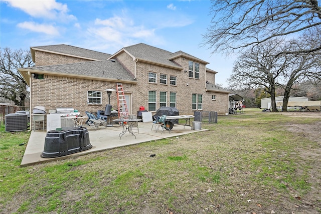 rear view of house featuring a lawn and a patio area