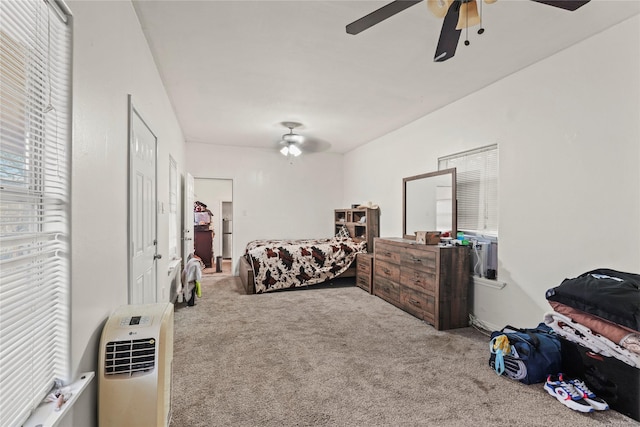 bedroom featuring ceiling fan, carpet floors, and heating unit