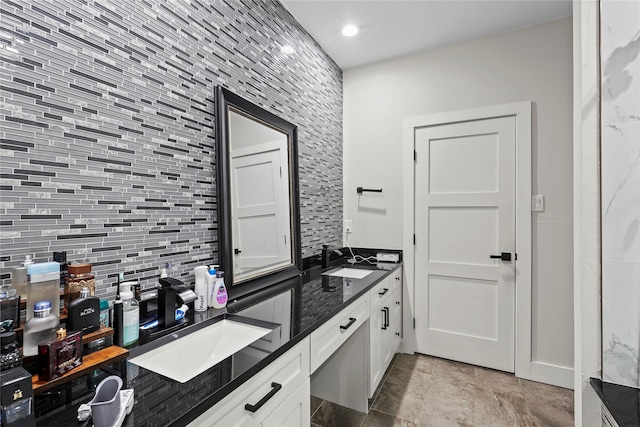 bathroom with vanity and decorative backsplash