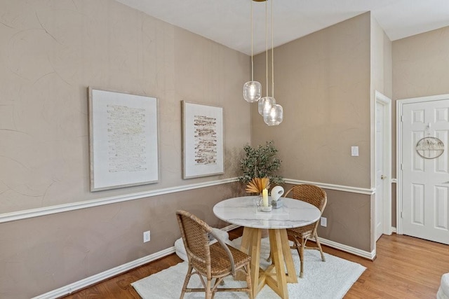 dining space with hardwood / wood-style floors