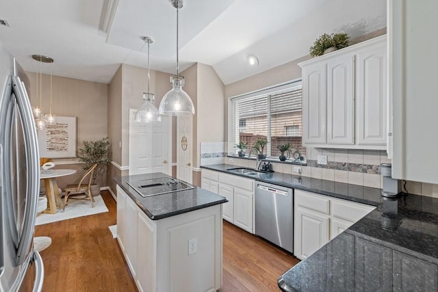 kitchen with sink, decorative light fixtures, white cabinets, and appliances with stainless steel finishes