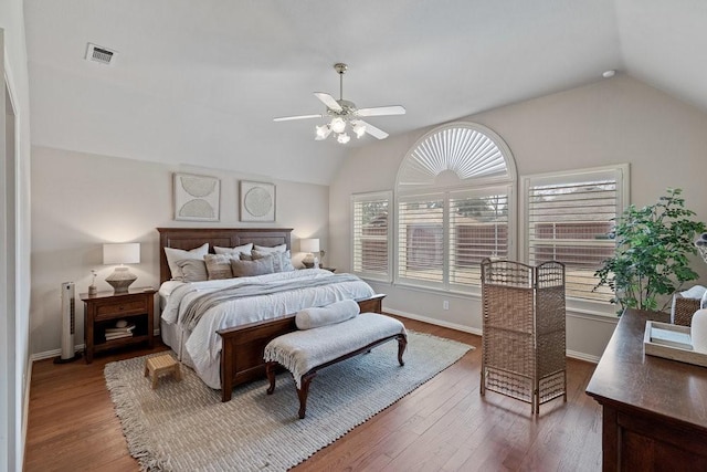 bedroom with dark wood-type flooring, ceiling fan, and vaulted ceiling