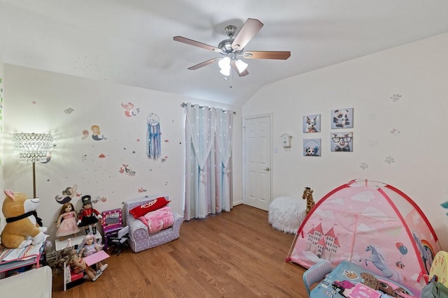 bedroom featuring ceiling fan, vaulted ceiling, and light wood-type flooring