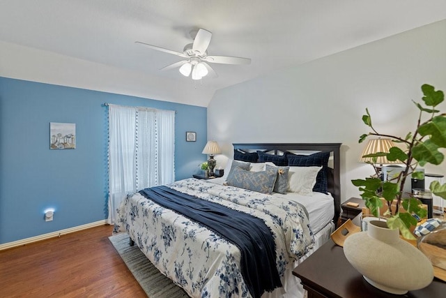 bedroom featuring ceiling fan, dark hardwood / wood-style floors, and vaulted ceiling