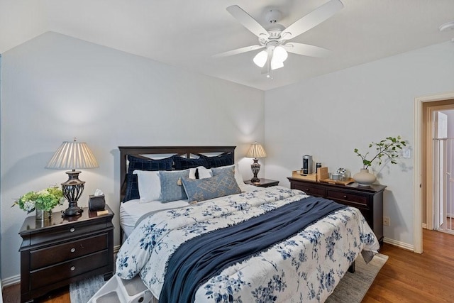 bedroom with hardwood / wood-style flooring, ceiling fan, and lofted ceiling