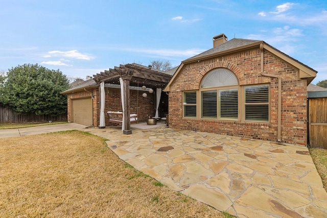 exterior space with a pergola, a garage, a front yard, and a patio