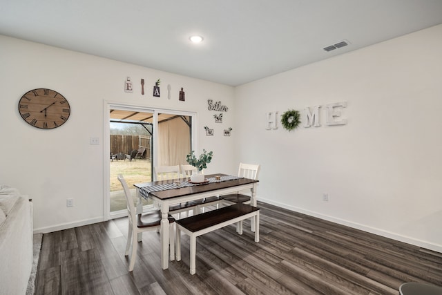 dining space featuring dark wood-type flooring