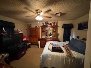 bedroom featuring carpet floors and a textured ceiling