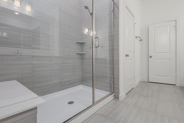 bathroom with walk in shower and tile patterned floors