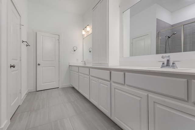 bathroom featuring vanity and a shower with shower door