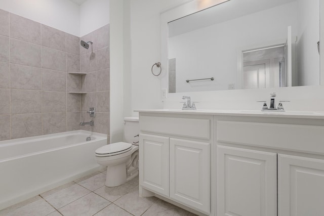 full bathroom featuring tiled shower / bath, vanity, toilet, and tile patterned flooring