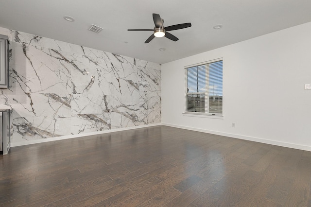 unfurnished room with ceiling fan and dark hardwood / wood-style floors