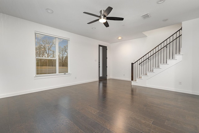 unfurnished living room with dark wood-type flooring and ceiling fan