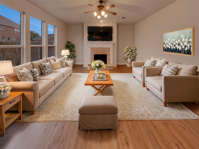 living room with ceiling fan and light wood-type flooring