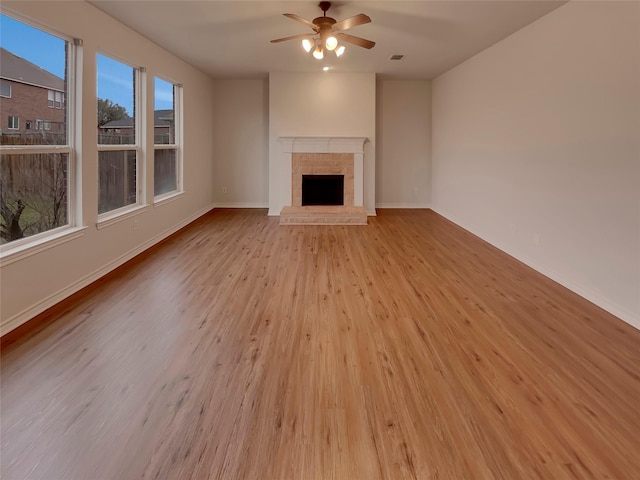 unfurnished living room with light wood-type flooring and ceiling fan