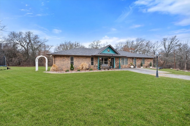 view of front of property featuring a trampoline and a front lawn