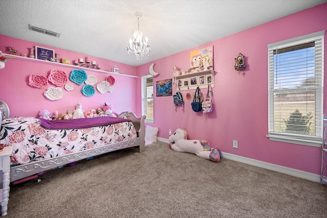 bedroom with an inviting chandelier, carpet, and a textured ceiling