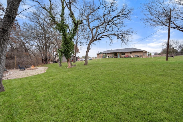 view of yard with a fire pit