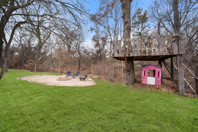 view of yard with a deck and a fire pit