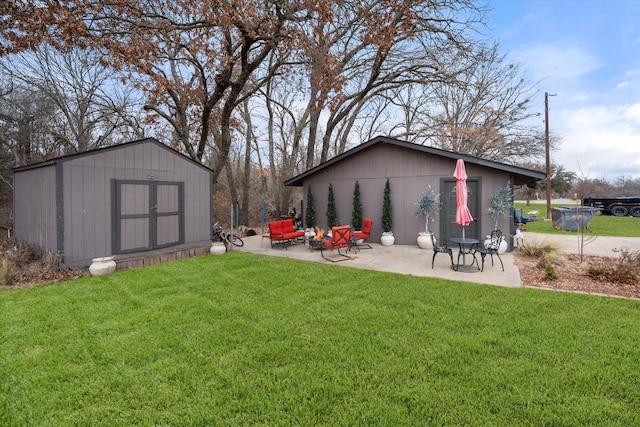 view of yard with a storage unit and a patio area