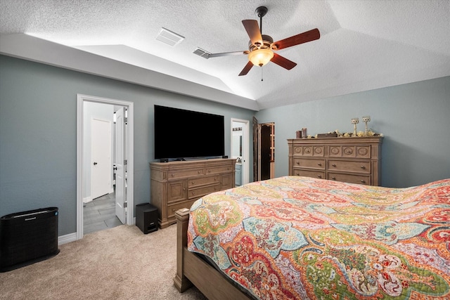 carpeted bedroom with ceiling fan, lofted ceiling, and a textured ceiling