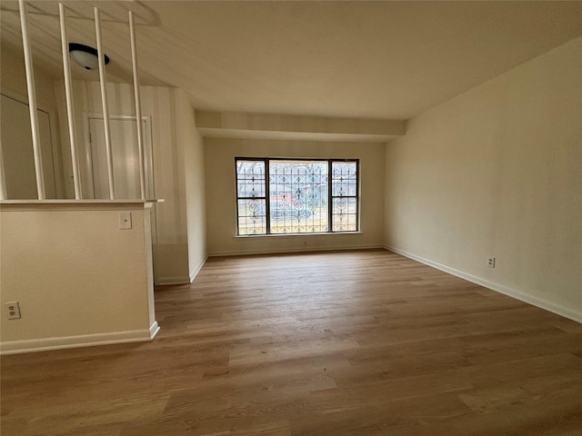 empty room with hardwood / wood-style floors