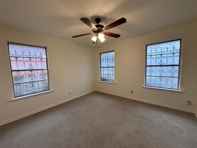 carpeted spare room with ceiling fan