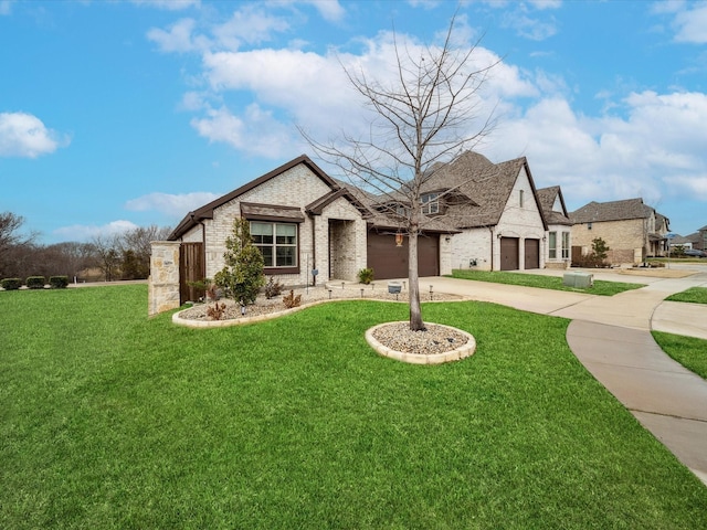 french country home featuring a garage and a front yard