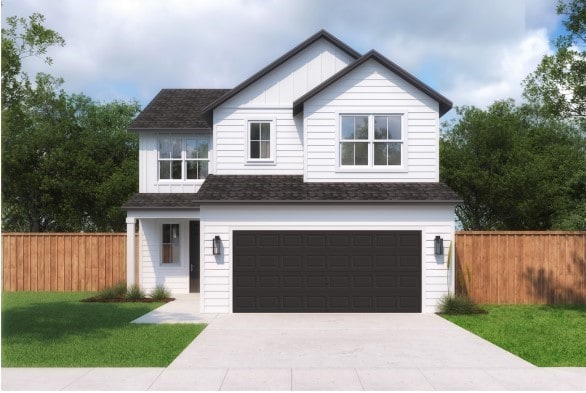 view of front of house with a garage and a front lawn