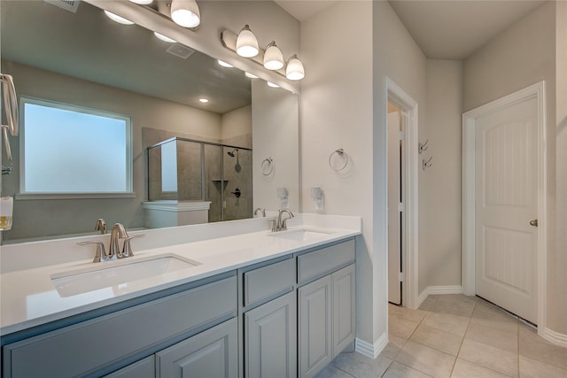 bathroom with walk in shower, vanity, and tile patterned flooring